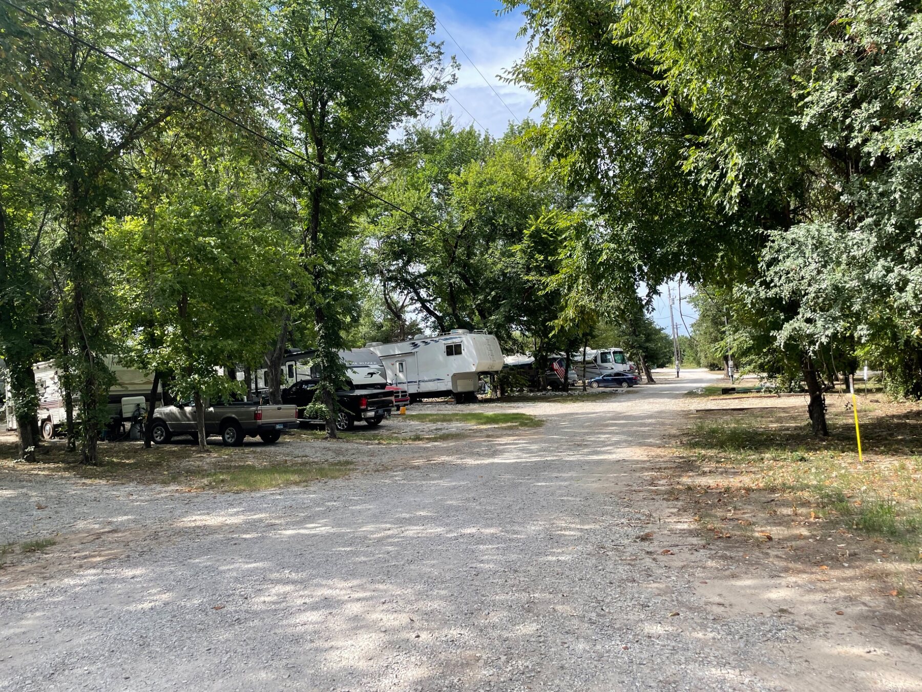 Wide gravel drive through Campfire RV Park